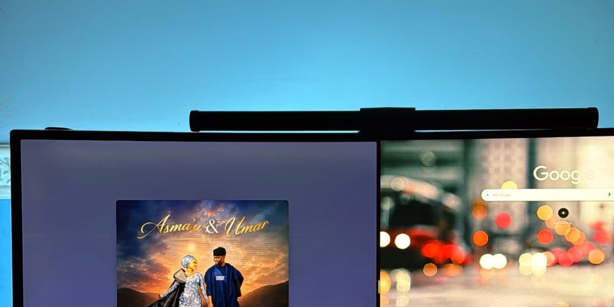 An album cover filling the ultrawide under a monitor light bar.