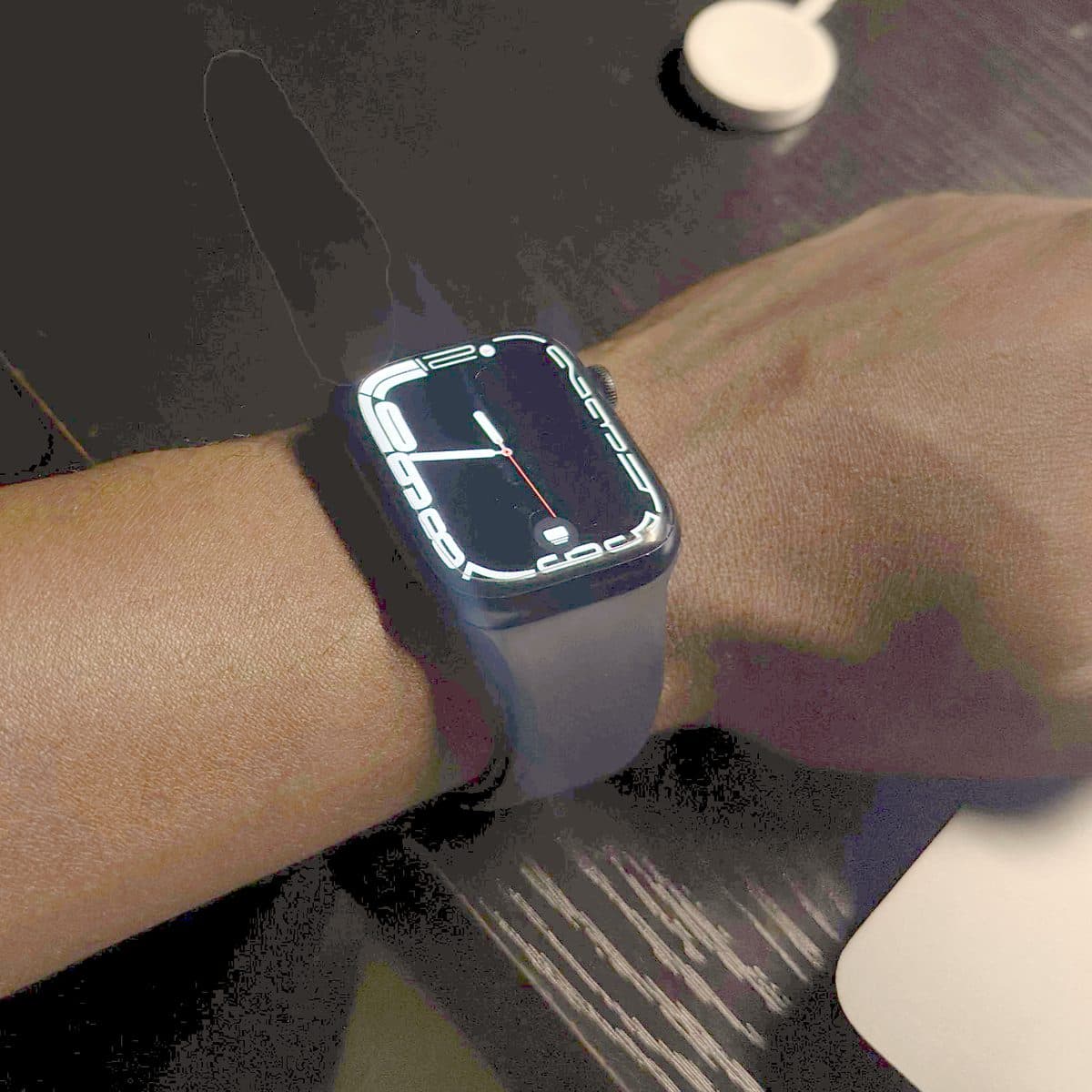 An Apple Watch lit up in a dark room.
